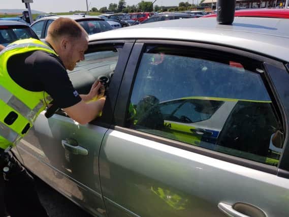 Police broke the car window to rescue the dog. Picture: Police Scotland