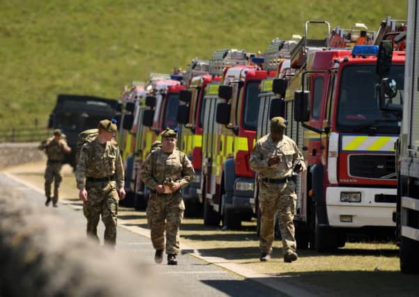 Members of the 4th Battalion, Royal Regiment of Scotland join firefighters as they prepare to fight a fire on Saddleworth moor near Stalybridge, northwest England. Picture: Oli SCARFFOLI SCARFF/AFP/Getty Images