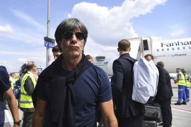 Head coach Joachim Low leaves a plane at Frankfurt airport as the dethroned world champions arrived back in Germany. Picture: AP