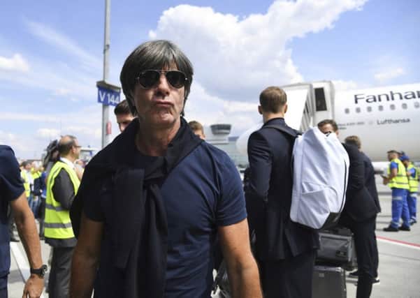 Head coach Joachim Low leaves a plane at Frankfurt airport as the dethroned world champions arrived back in Germany. Picture: AP