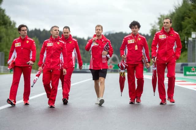 Ferrari driver Sebastian Vettel, centre, inspects the racetrack ahead of Sundays Austrian Grand Prix at the Red Bull Ring in Spielberg. Picture: AFP/Getty