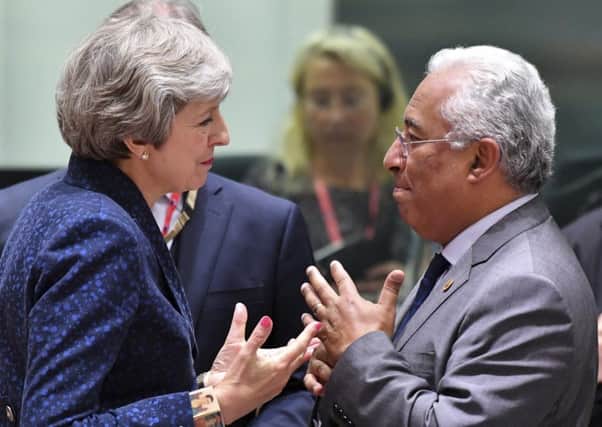 Portuguese Prime Minister Antonio Costa, right, speaks with British Prime Minister Theresa May during a round table meeting at the EU summit in Brussels. Picture: AP Photo/Geert Vanden Wijngaert