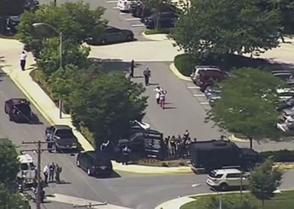 People leave the Capital Gazette newspaper after multiple people have been shot in Annapolis, Md. (WJLA via AP)