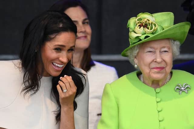 Queen Elizabeth II sits and laughs with Meghan, Duchess of Sussex during a ceremony to open the new Mersey Gateway Bridge. Picture: Jeff J Mitchell/Getty Images
