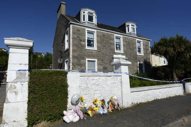 Tributes have been left outside the house where 6-year-old Alesha MacPhail had been staying. Pic: SWNS