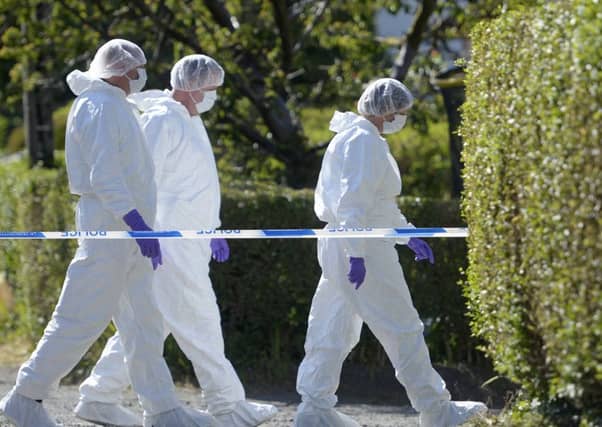 A police forensic team team at the house were six-year-old Alesha MacPhail had been staying on the Isle of Bute outside Rothesay