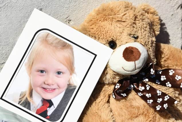 A school picture of Alesha MacPhail is left in tribute on Bute. Picture: Getty