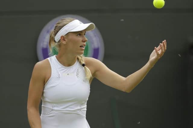 Insects fly around as Caroline Wozniacki prepares to serve. Picture: AP