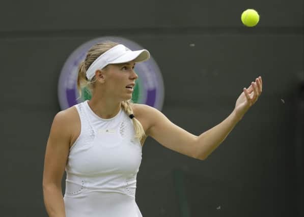 Insects fly around as Caroline Wozniacki prepares to serve. Picture: AP