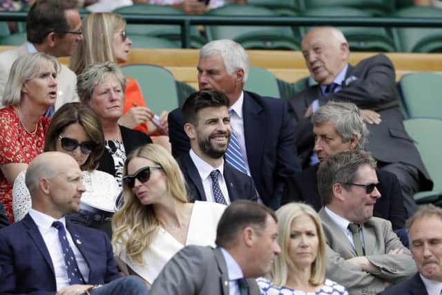 Spanish defender Gerard Pique takes in the action on centre court. Picture: AP