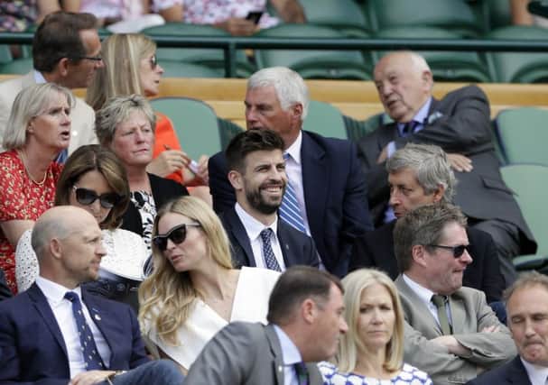 Spanish defender Gerard Pique takes in the action on centre court. Picture: AP