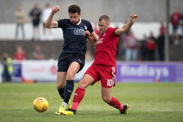 Lewis Kidd battling with Niall McGinn. (Pic: Ian Sneddon)