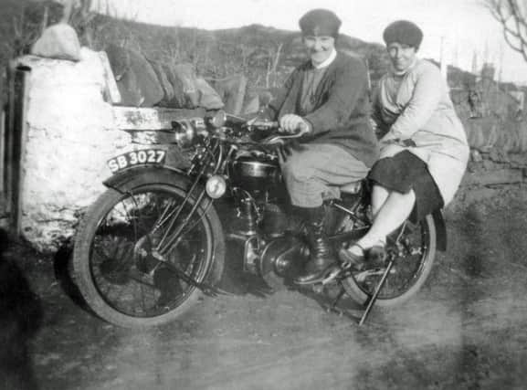 A Queen's Nurse with the Highlands and Islands Medical Service on motorbike with friend on the island of Bernera. PIC: Islands Book Trust/Bernera Historical Society.
