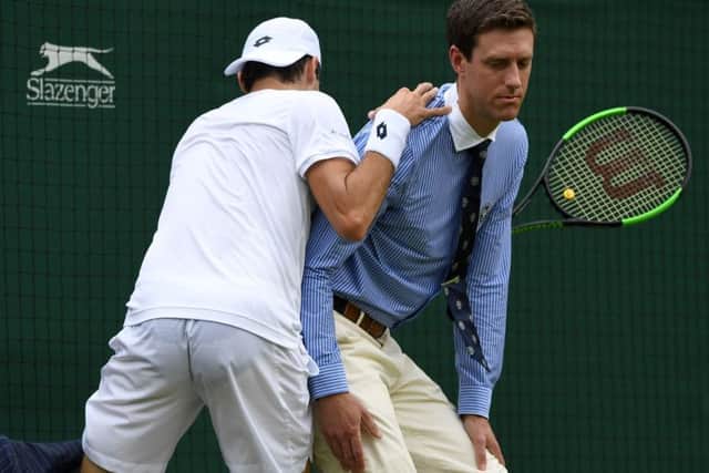 Guido Pella bumps into a line judge against Marin Cilic. Picture: Glyn Kirk/AFP/Getty Images