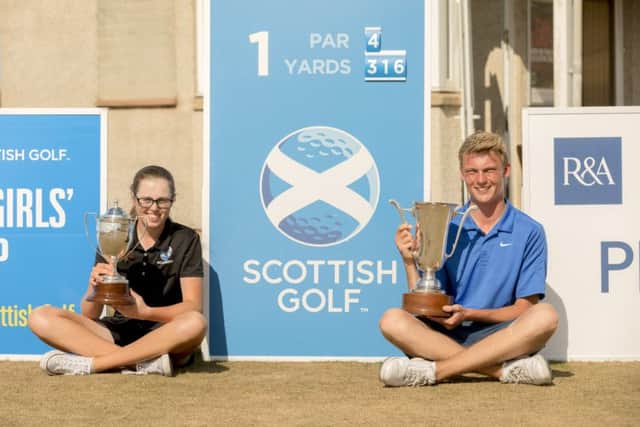 Connor Wilson and Hannah Darling with their trophies at Moray Golf Club. Picture: Malcolm McCurrach