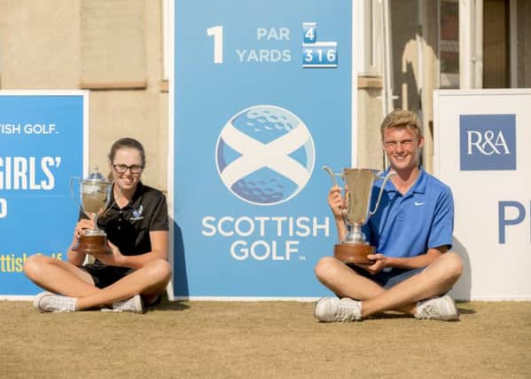 Connor Wilson and Hannah Darling with their trophies at  Moray Golf Club. Picture: Malcolm McCurrach