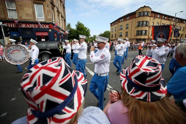 A priest was spat at and verbally abused during an Orange Walk in Glasgow