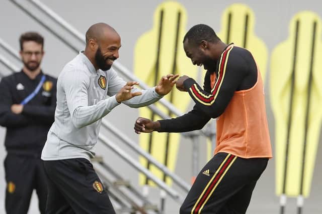 Belgium assistant coach Thierry Henry, left, jokes with Romelu Lukaku during training. Picture: Alexander Zemlianichenko/AP