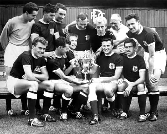 The Dundee players with the First Division trophy after the 1961-1962 season.
Back row left to right: Pat Liney, Gordon Smith, Alan Gilzean, Bobby Wishart, Ian Ure, trainer Sammy Kean and right half Bobby Seith. 
Front row: Andy Penman, Bobby Cox, Alex Hamilton, Alan Cousin and Hugh Robertson.