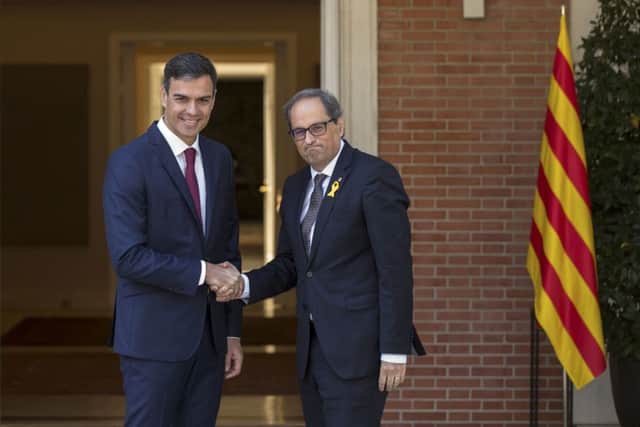 Spain's Prime Minister Pedro Sanchez, left, welcomes Catalan regional president Quim Torra on his arrival for talks at the Moncloa palace in Madrid. Picture: AP Photo/Andrea Comas