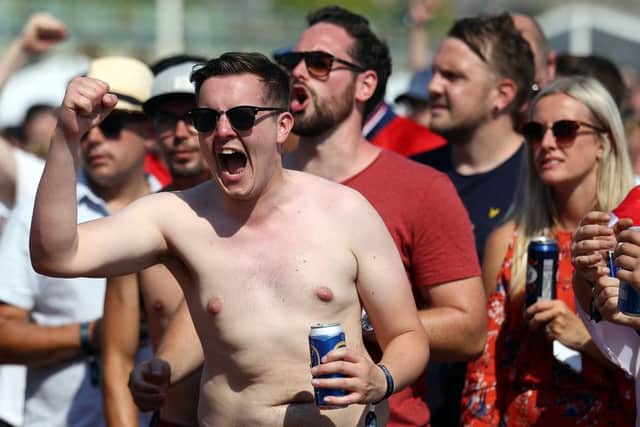 Football fans watch England take on Sweden in The World Cup Quarter Finals at Luna Beach Cinema on Brighton Beach.  (Photo by Bryn Lennon/Getty Images)