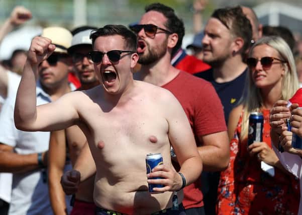 Football fans watch England take on Sweden in The World Cup Quarter Finals at Luna Beach Cinema on Brighton Beach. (Photo by Bryn Lennon/Getty Images)