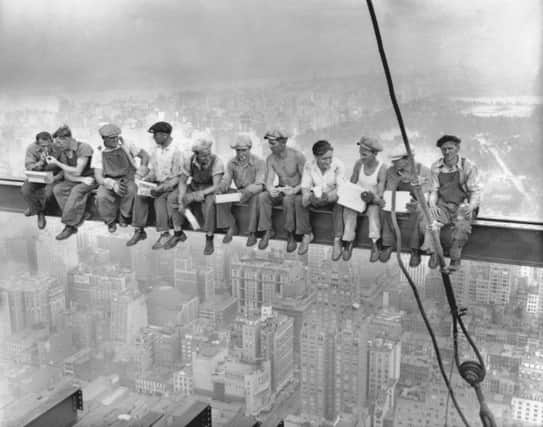 While New York's thousands rush to crowded restaurants and congested lunch counters for their noon day lunch, these intrepid steel workers sat atop the 70-story RCA building in Rockefeller Center