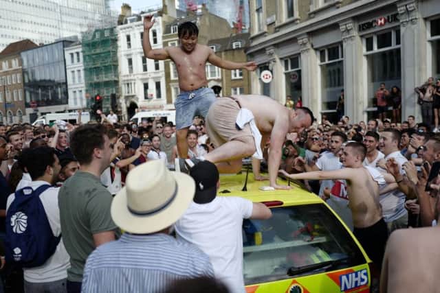 People dance on a NHS ambulance as fans celebrate in the street beside Borough Market after England's win over Sweden in the World Cup quater-finals. Picture: Akmentolga Akmen/Getty Images
