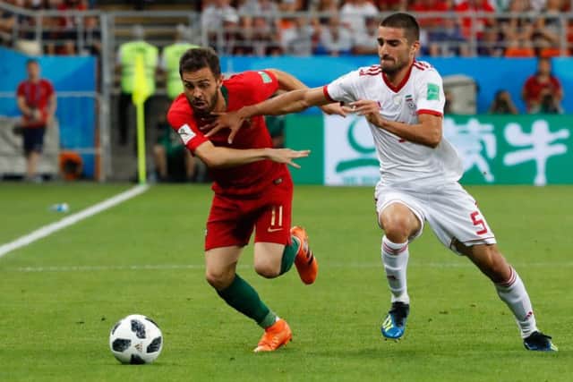 Milad Mohammadi tries to shackle Bernardo Silva during Iran's Group B meeting with Portugal last month. Picture: Getty Images