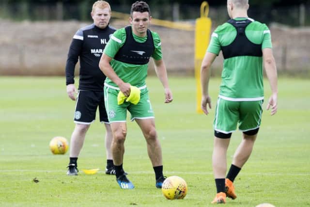 Neil Lennon keeps a close eye on John McGinn as the player takes part in Hibs training. Picture: SNS