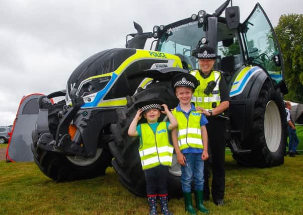 The police tractor with PC Lyndsey McLean, Harry Ratcliffe and his brother Tom.