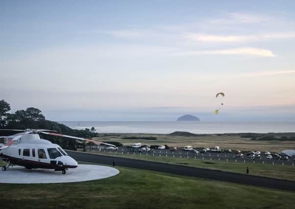 A protester flew a paraglider over Donald Trump's resort in Turnberry, South Ayrshire, with a banner reading "Trump: Well Below Par", shortly after the US President arrived at the hotel. Picture: PA