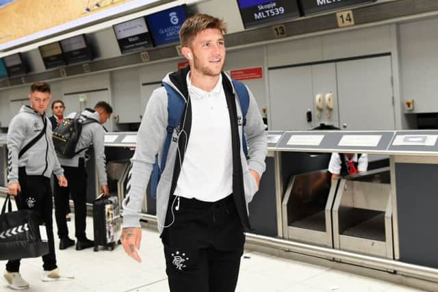 Josh Windass completes check-in at Glasgow Airport yesterday as Rangers set off for their Europa League qualifier in Macedonia. Picture: SNS.