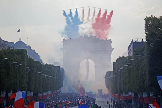 The Patrouille de France display team fly Le Tricolore above the Champs-Elysees as France celebrates the return of the World Cup. Picture: Getty