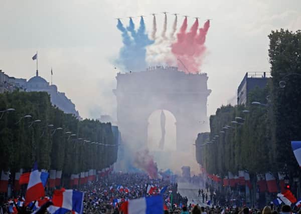 The Patrouille de France display team fly Le Tricolore above the Champs-Elysees as France celebrates the return of the World Cup. Picture: Getty