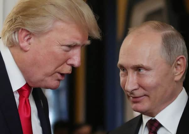 Wannabe tough guy Donald Trump seems drawn to Vladimir Putin's thuggish strength (Picture: AFP/Getty)