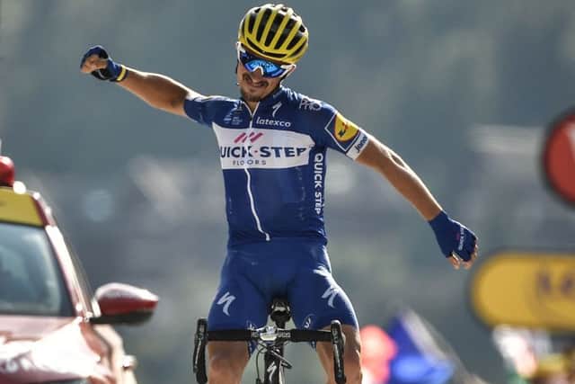 France's Julian Alaphilippe celebrates as he crosses the line to win the tenth stage of the Tour de France. Picture: Marco Bertorello/AFP/Getty Images