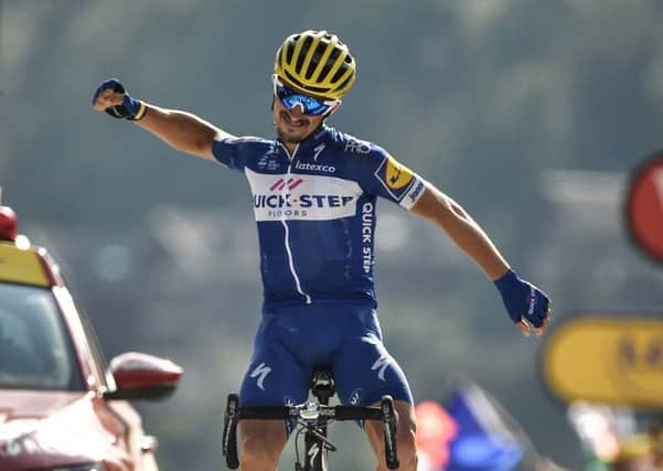 France's Julian Alaphilippe celebrates as he crosses the line to win the tenth stage of the Tour de France. Picture: Marco Bertorello/AFP/Getty Images