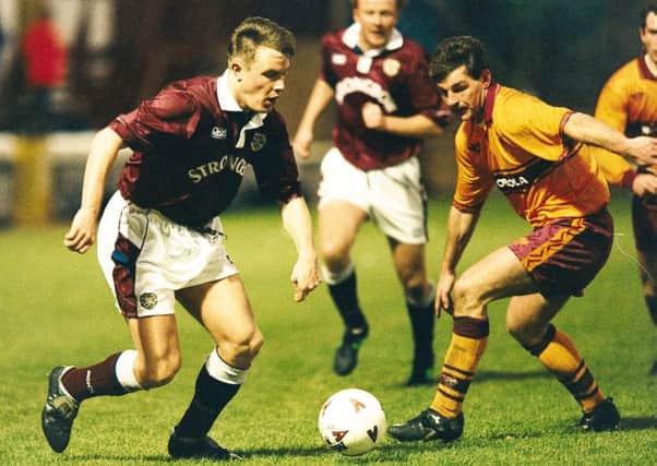 David Hagen (left) runs at John Philiben of Motherwell in a game at Fir Park in 1995. Picture: TSPL