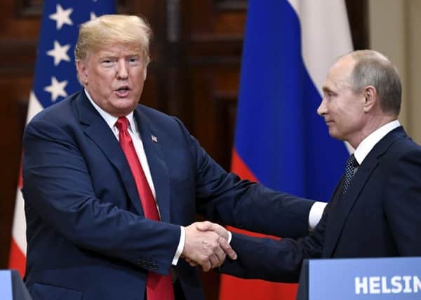 U.S. President Donald Trump and Russian President Vladimir Putin shake hands after a joint press conference at the Presidential Palace in Helsinki, Finland. Picture: Jussi Nukari/Lehtikuva via AP