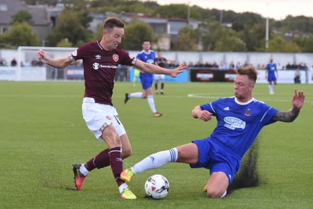 Hearts' Steven MacLean is tackled by Cove's Ryan Strachan. Picture: Gary Hutchison/SNS