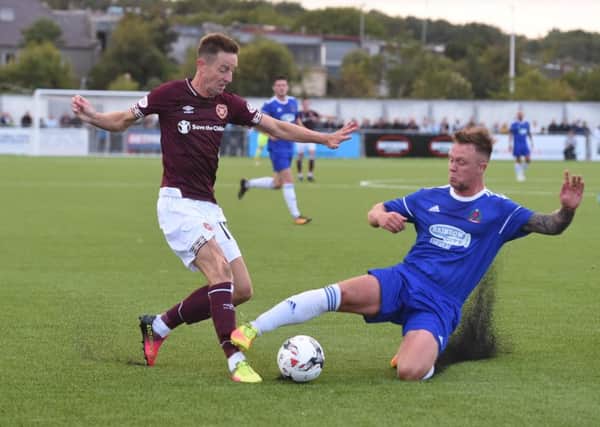 Hearts' Steven MacLean is tackled by Cove's Ryan Strachan. Picture: Gary Hutchison/SNS