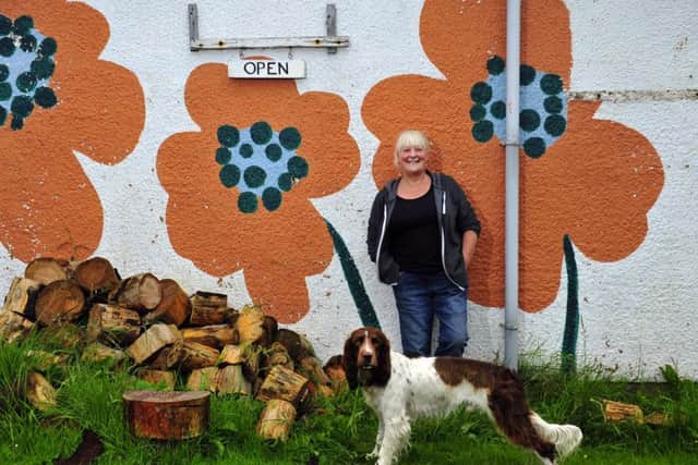 Anita Wilson with her dog, Shuggy, outside Cast Off Crafts in Balnakeil Craft village, near Durness. Picture: Robert Perry