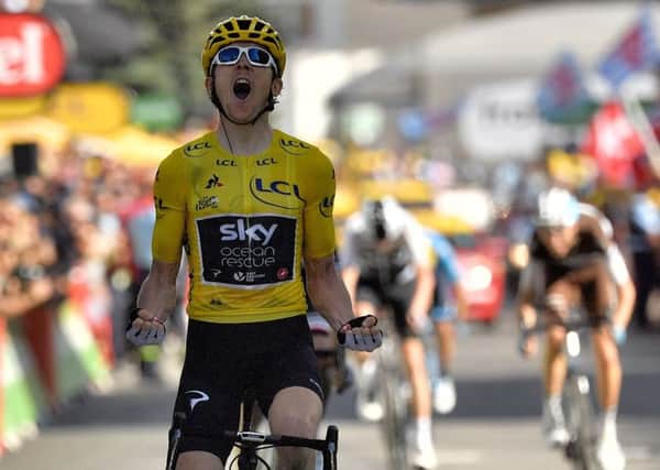 Geraint Thomas roars as he crosses the finishing line. Picture Marco Bertorello/AFP/GETTY