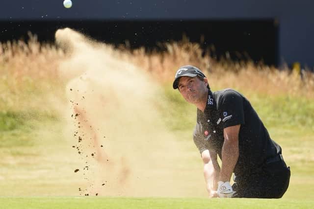 US golfer Kevin Kisner plays out of a green-side bunker on the 18th hole. Picture: Paul Ellis/AFP/Getty Images