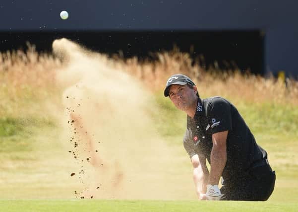 US golfer Kevin Kisner plays out of a green-side bunker on the 18th hole. Picture: Paul Ellis/AFP/Getty Images