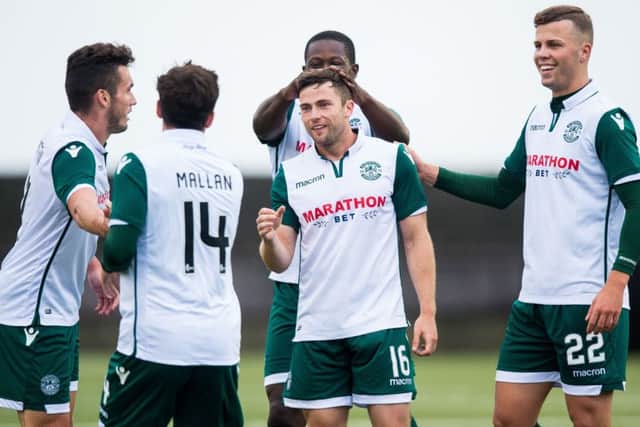 The Hibs players celebrate after Lewis Stevenson (centre) nets a stunning goal. Picture: SNS