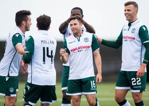 The Hibs players celebrate after Lewis Stevenson (centre) nets a stunning goal. Picture: SNS