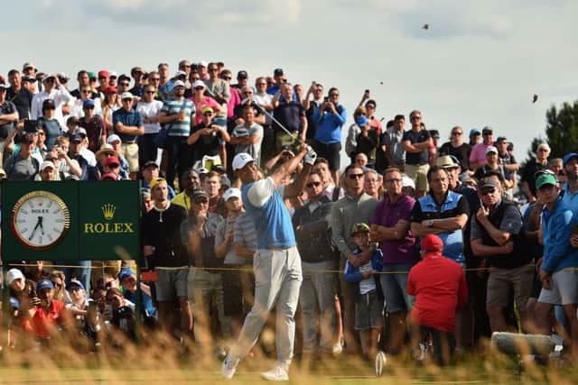 A huge gallery watches Tiger Woods tee off at the 9th hole. Picture: Glyn Kirk/AFP/Getty