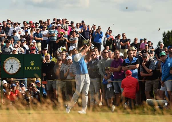 A huge gallery watches Tiger Woods tee off at the 9th hole. Picture: Glyn Kirk/AFP/Getty